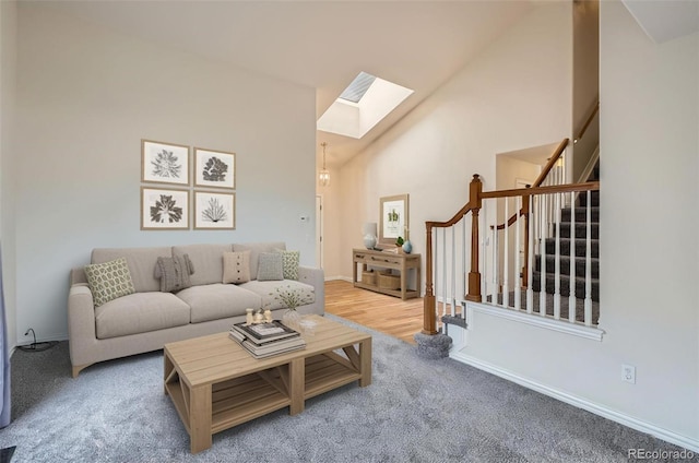 16645 W 2nd Ave, Golden, CO 80401 - living room with a skylight, stairs, carpet floors, and high vaulted ceiling