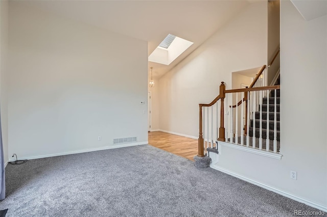 16645 W 2nd Ave, Golden, CO 80401 - unfurnished room featuring a skylight, carpet floors, stairs, and vaulted ceiling