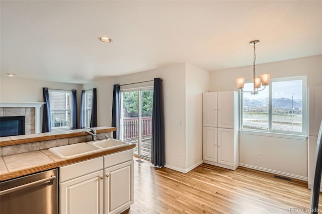 16645 W 2nd Ave, Golden, CO 80401 - kitchen featuring stainless steel dishwasher, a chandelier, light wood-style flooring, white cabinets, and recessed lighting