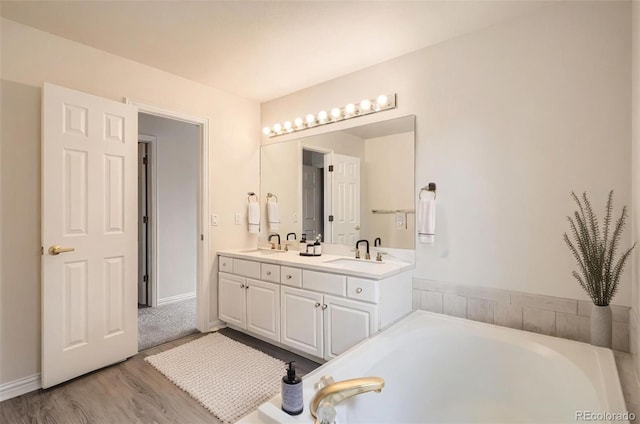 16645 W 2nd Ave, Golden, CO 80401 - bathroom featuring double vanity, a bath, and wood finished floors