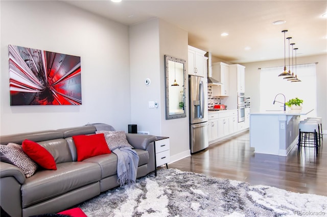 15878 E Broncos Pl, Englewood, CO 80112 - living area featuring wood finished floors, recessed lighting, and baseboards