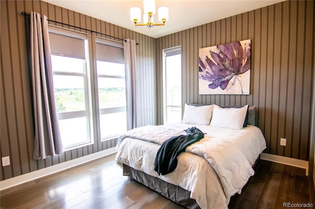 15878 E Broncos Pl, Englewood, CO 80112 - bedroom with wallpapered walls, hardwood / wood-style flooring, a chandelier, multiple windows, and baseboards