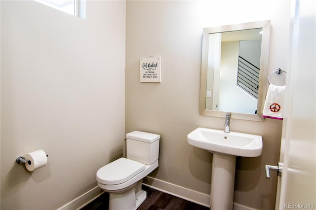 15878 E Broncos Pl, Englewood, CO 80112 - half bath with toilet, wood finished floors, and baseboards