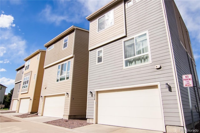 15878 E Broncos Pl, Englewood, CO 80112 - back of house featuring a garage and driveway