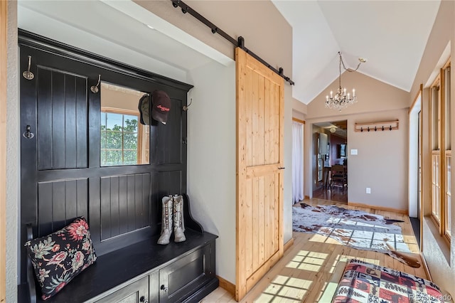 903 High Rd, Manitou Springs, CO 80829 - mudroom featuring vaulted ceiling, a chandelier, a barn door, and light wood-type flooring