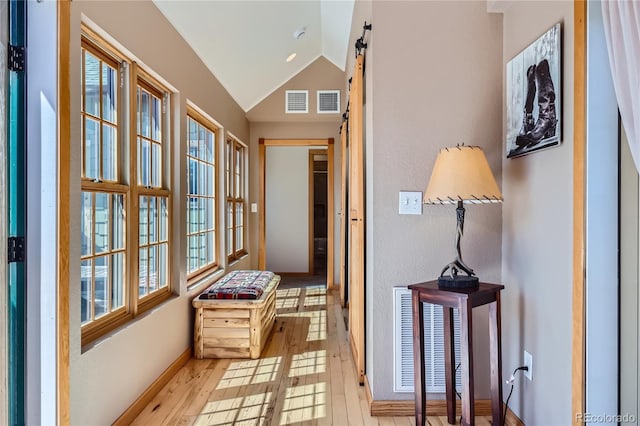 903 High Rd, Manitou Springs, CO 80829 - hall with lofted ceiling, wood finished floors, and a barn door