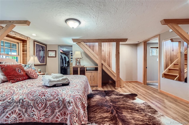 903 High Rd, Manitou Springs, CO 80829 - bedroom with light wood-style floors, a textured ceiling, and a spacious closet