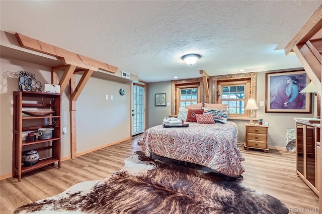 903 High Rd, Manitou Springs, CO 80829 - bedroom with light wood-style floors and a textured ceiling