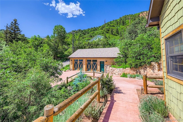 903 High Rd, Manitou Springs, CO 80829 - view of patio with an outdoor structure and a view of trees