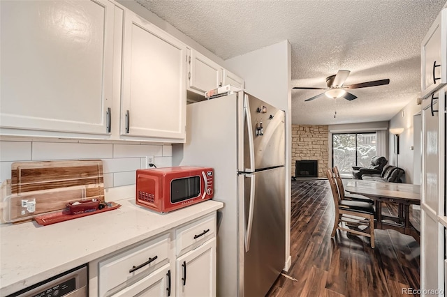 kitchen with white cabinetry, dark hardwood / wood-style flooring, ceiling fan, and appliances with stainless steel finishes