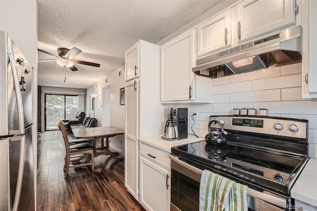 kitchen with appliances with stainless steel finishes, tasteful backsplash, ceiling fan, white cabinets, and dark hardwood / wood-style flooring