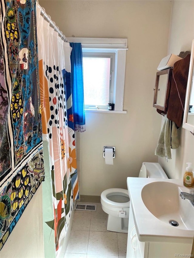 bathroom with a shower with shower curtain, vanity, toilet, and tile patterned flooring