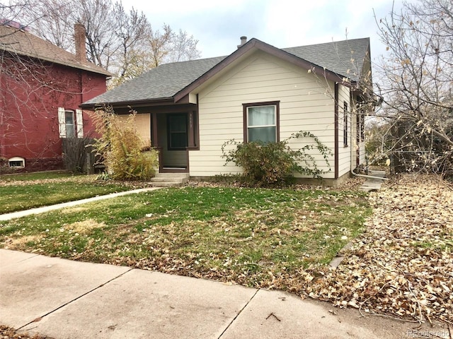 3953 Vrain St, Denver, CO 80212 - view of front of property featuring a front yard, roof with shingles, and entry steps