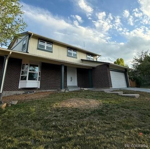 8694 E Eastman Ave, Denver, CO 80231 - view of front of property featuring a garage, brick siding, and a front lawn