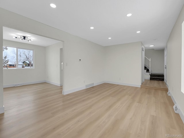 8694 E Eastman Ave, Denver, CO 80231 - unfurnished living room with stairs, light wood-style flooring, recessed lighting, and baseboards