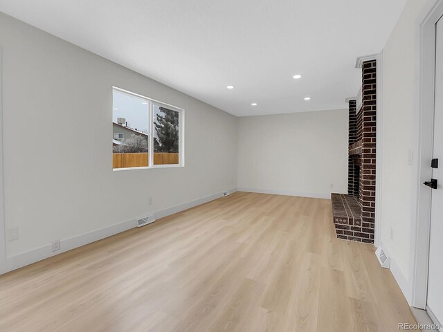 8694 E Eastman Ave, Denver, CO 80231 - unfurnished living room with recessed lighting, light wood-style floors, a fireplace, and baseboards