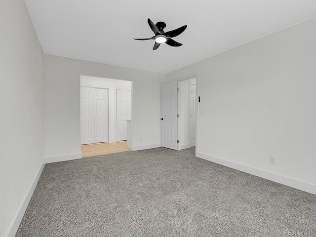 8694 E Eastman Ave, Denver, CO 80231 - unfurnished bedroom featuring carpet floors, baseboards, two closets, and a ceiling fan