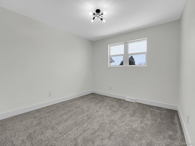 8694 E Eastman Ave, Denver, CO 80231 - unfurnished room with carpet floors, baseboards, and a chandelier