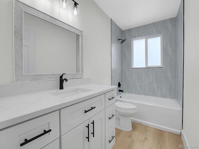 8694 E Eastman Ave, Denver, CO 80231 - bathroom featuring vanity, toilet, wood finished floors, and washtub / shower combination
