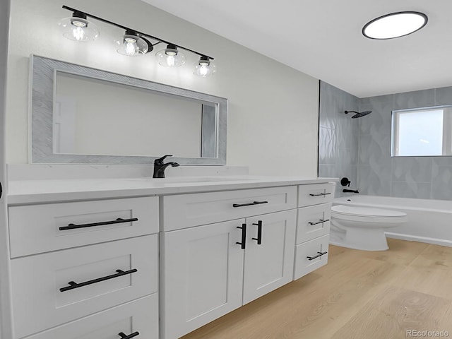 8694 E Eastman Ave, Denver, CO 80231 - full bathroom featuring vanity, wood finished floors, toilet, and shower / bathtub combination