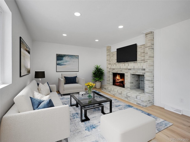 8694 E Eastman Ave, Denver, CO 80231 - living room with wood finished floors, recessed lighting, and a brick fireplace