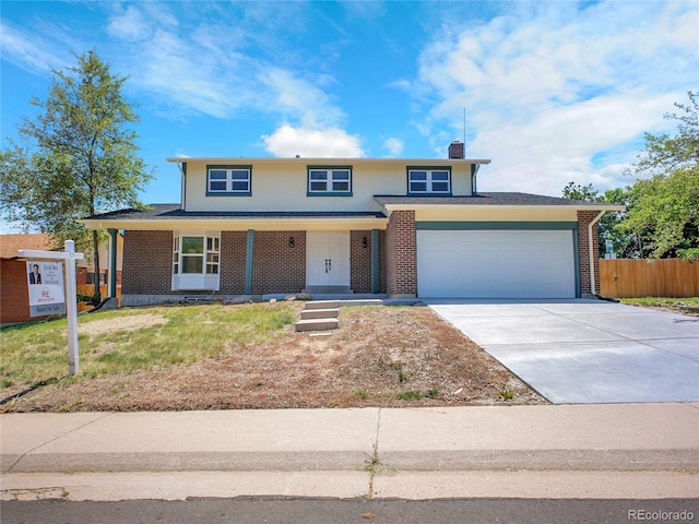 8694 E Eastman Ave, Denver, CO 80231 - view of front of property featuring an attached garage, driveway, brick siding, and a chimney
