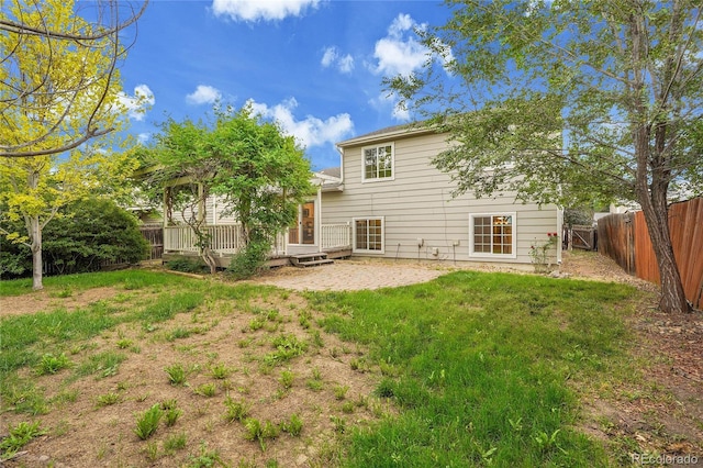 1717 Tulip St, Longmont, CO 80501 - rear view of property featuring a fenced backyard, a wooden deck, and a patio area