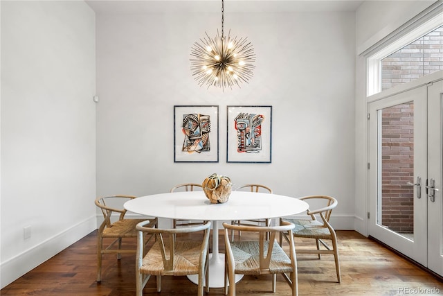 dining area featuring hardwood / wood-style flooring and a notable chandelier