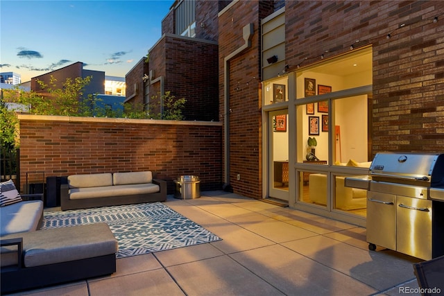 view of patio / terrace with exterior kitchen, outdoor lounge area, and a grill