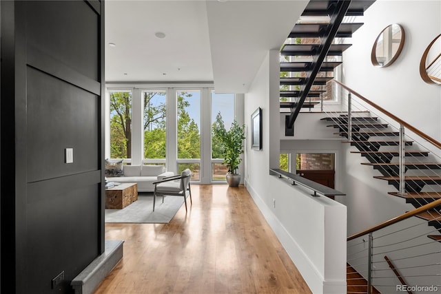 interior space featuring floor to ceiling windows and light hardwood / wood-style flooring