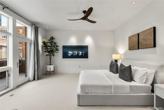 carpeted bedroom with ceiling fan and access to outside