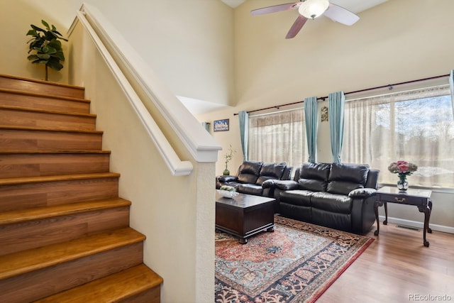 living room featuring hardwood / wood-style flooring and ceiling fan