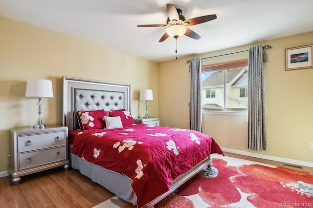 bedroom featuring ceiling fan and dark hardwood / wood-style floors