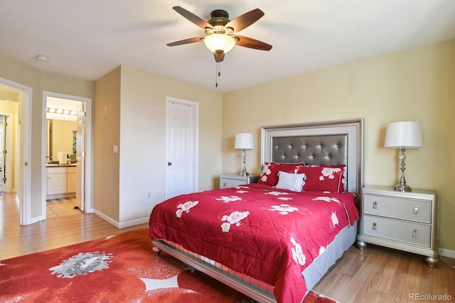 bedroom featuring light wood-type flooring, connected bathroom, and ceiling fan