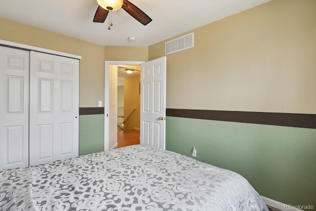 bedroom with ceiling fan and a closet