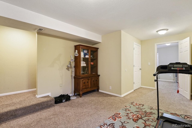 exercise room with light carpet