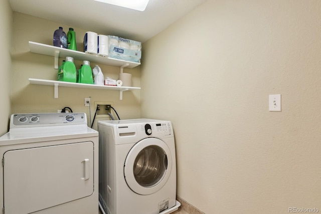 clothes washing area with separate washer and dryer