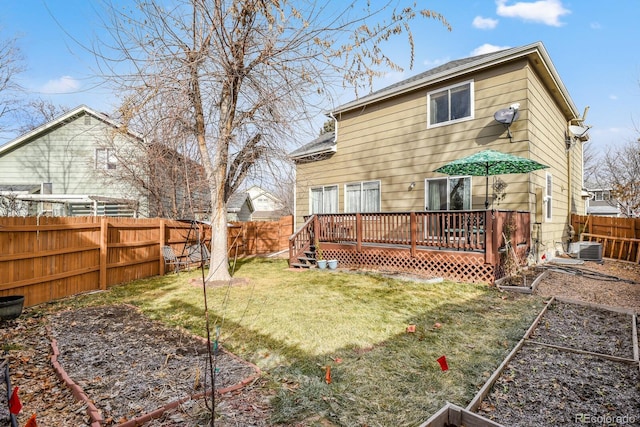 rear view of house with a lawn, central AC unit, and a deck