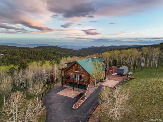 11690 Rampart Range Rd, Woodland Park, CO 80863 - view of subject property featuring a heavily wooded area and a mountain backdrop