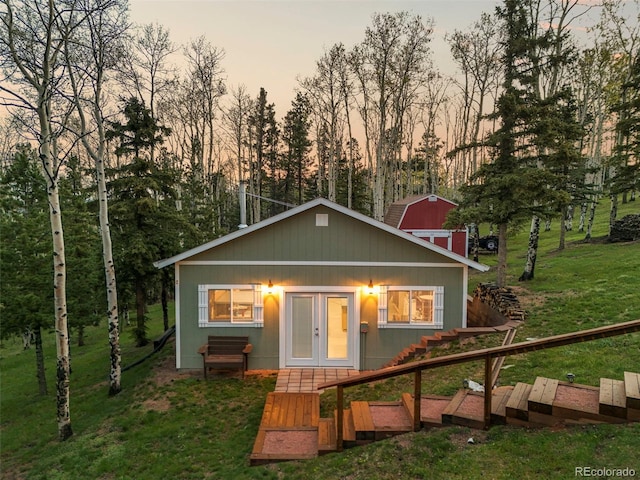 11690 Rampart Range Rd, Woodland Park, CO 80863 - back of house featuring french doors and a lawn