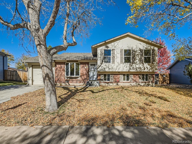 split level home featuring a front lawn and a garage