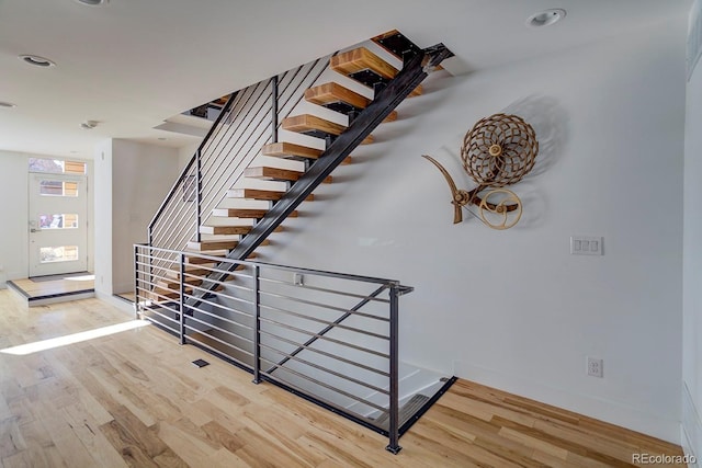 staircase with hardwood / wood-style flooring