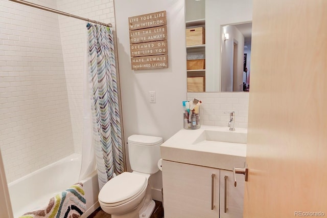 full bathroom featuring vanity, toilet, backsplash, and shower / tub combo