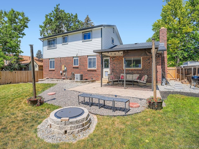 7520 Braun Ct, Arvada, CO 80005 - rear view of property with an outdoor living space with a fire pit, a patio area, a fenced backyard, brick siding, and a chimney
