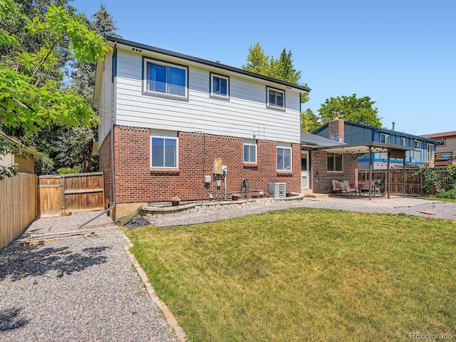 7520 Braun Ct, Arvada, CO 80005 - rear view of property with a patio, a fenced backyard, brick siding, and a gate