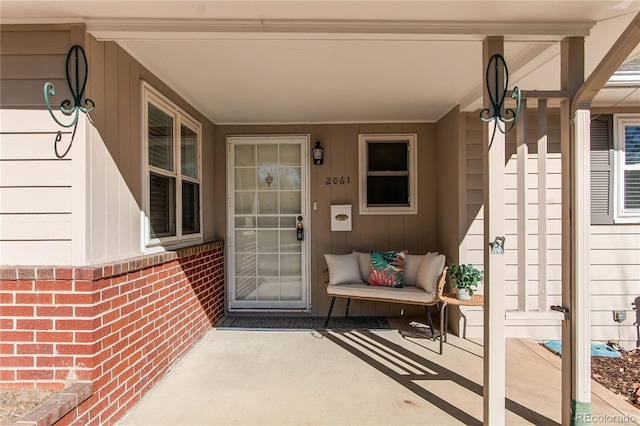 entrance to property featuring brick siding