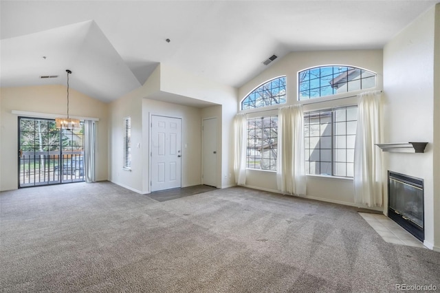 2172 Denton Grv Unit 203, Colorado Springs, CO 80919 - unfurnished living room featuring vaulted ceiling, an inviting chandelier, carpet floors, and plenty of natural light