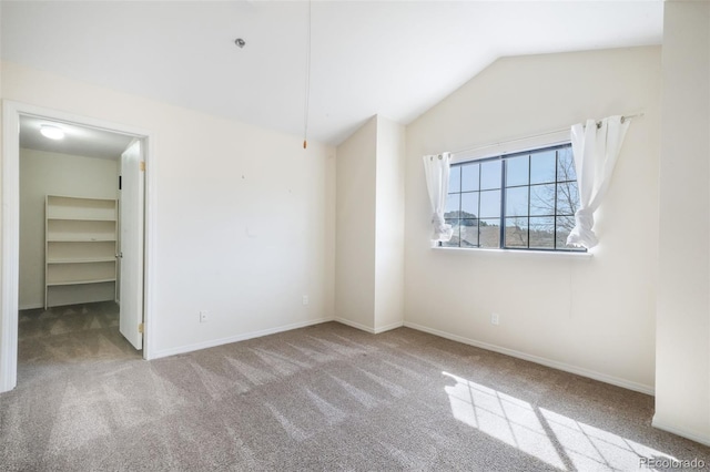 2172 Denton Grv Unit 203, Colorado Springs, CO 80919 - unfurnished bedroom with lofted ceiling, a spacious closet, carpet floors, and baseboards