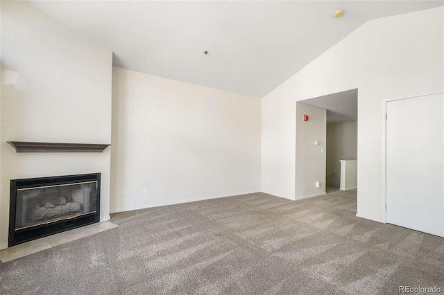2172 Denton Grv Unit 203, Colorado Springs, CO 80919 - unfurnished living room with carpet flooring, baseboards, a fireplace with flush hearth, and high vaulted ceiling