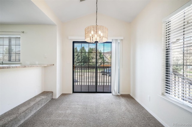 2172 Denton Grv Unit 203, Colorado Springs, CO 80919 - interior space featuring vaulted ceiling, baseboards, carpet floors, and a notable chandelier